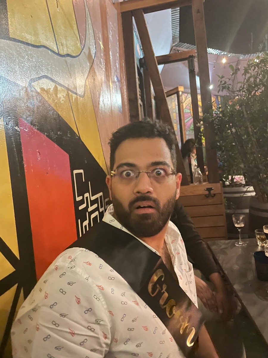 Rohith wearing a Groom sash looking shocked